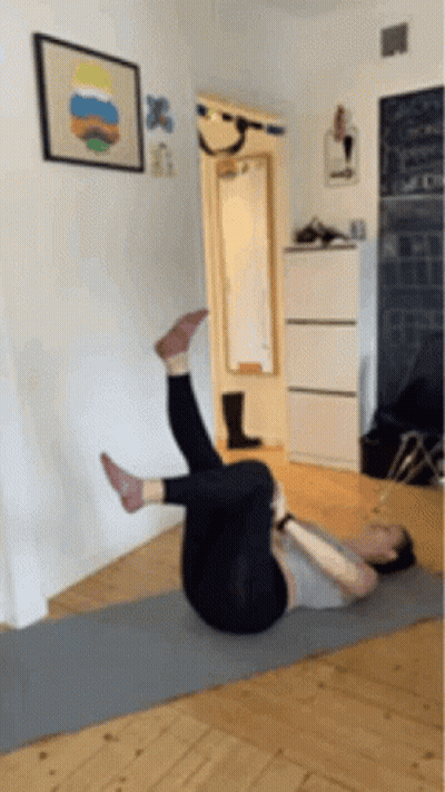 Woman Laying On Yoga Mat Legs Up GIF