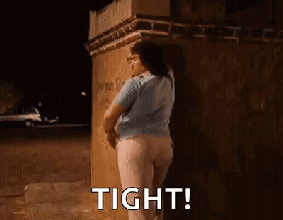 Woman Leaning Against Brick Wall At Night GIF