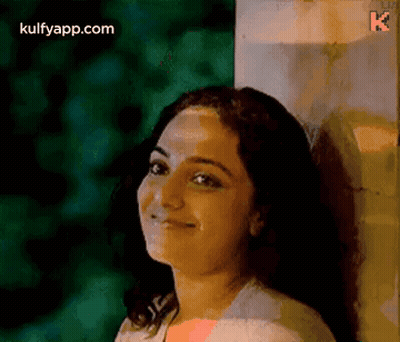 Woman Leaning Against Wall Smiling GIF