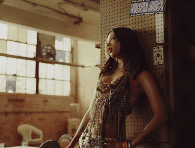 Woman Leaning Against Wall With Nicen Juicy Sign GIF