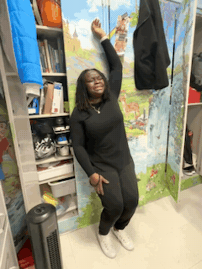 Woman Leaning Against Wall With Painting In Closet GIF