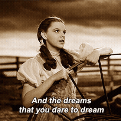 Woman Leaning On Railing With Dream Words GIF