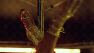 Woman Leg Hanging From Pole With Clear Shoe GIF