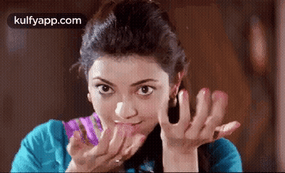 Woman Licking Lips In Blue Shirt GIF