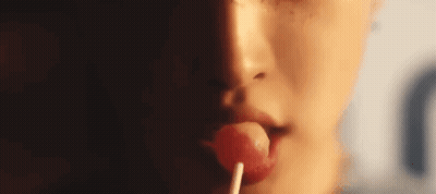 Woman Licking Lollipop Close-Up GIF