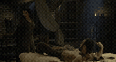 Woman Looking At Another Woman In Dark Room GIF