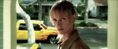 Woman Looking At Camera By Yellow Truck GIF