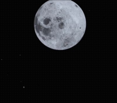 Woman Looking At Camera In Front Of Full Moon GIF