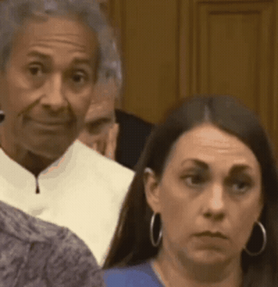 Woman Looking At Camera In Room GIF