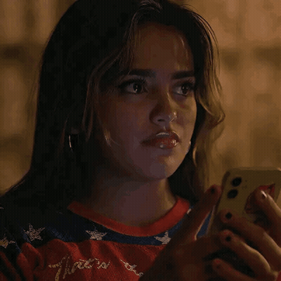 Woman Looking At Cell Phone In Dark GIF