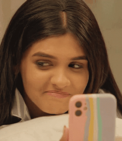 Woman Looking At Cell Phone Making Face GIF