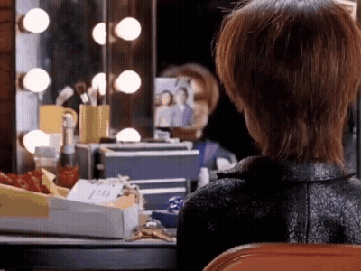 Woman Looking At Herself In Dressing Room Mirror GIF