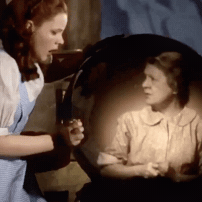 Woman Looking At Herself In Mirror GIF