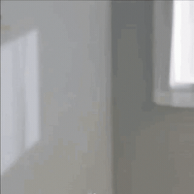 Woman Looking At Herself In Mirror With Bun GIF