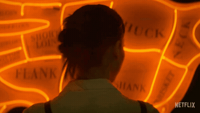 Woman Looking At Netflix Neon Sign GIF