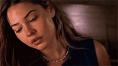 Woman Looking Down With Necklace And Earrings GIF