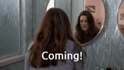 Woman Looking In Bathroom Mirror Saying Coming GIF