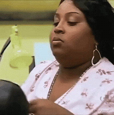 Woman Looking In Mirror Wearing Earrings GIF