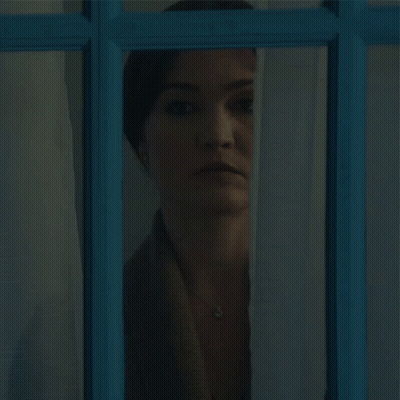 Woman Looking Out Blue Window GIF