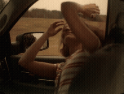 Woman Looking Out Car Window Holding Head GIF