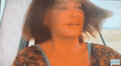 Woman Looking Out Car Window With Hair Blowing In Wind GIF