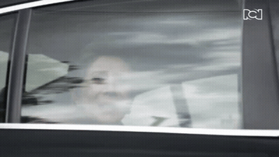 Woman Looking Out Car Window With Letter C GIF