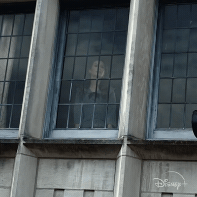 Woman Looking Out Window With Disney Logo