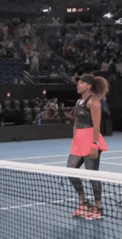 Woman Looking Over Net On Tennis Court GIF