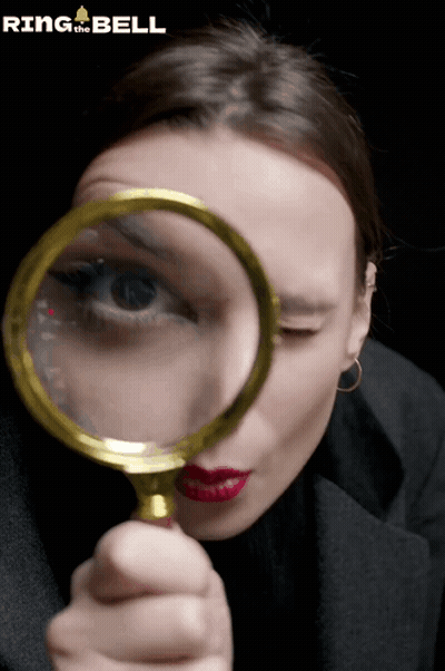 Woman Looking Through Magnifying Glass GIF