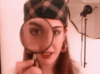 Woman Looking Through Magnifying Glass GIF