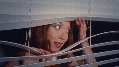 Woman Looking Through Window Blind Mouth Open GIF