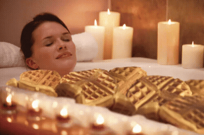 Woman Lying In Bathtub Surrounded By Candles GIF