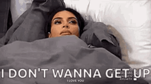 Woman Lying In Bed Under Blanket I Don't Wanna Get Up GIF