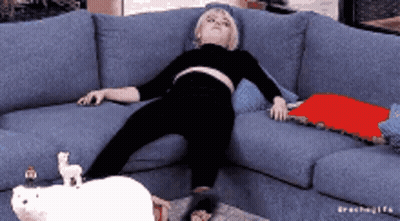 Woman Lying On Blue Couch With Stuffed Animal On Floor GIF