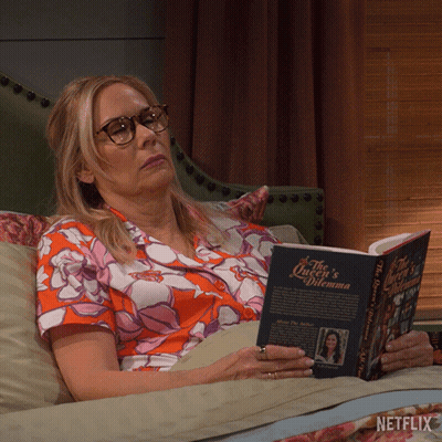 Woman Lying On Couch Reading Queen's Dilemma GIF