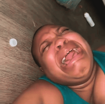Woman Lying On Floor Making Funny Face GIF