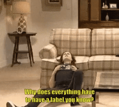 Woman Lying On Floor Saying Why Does Everything Have To Have A Label GIF