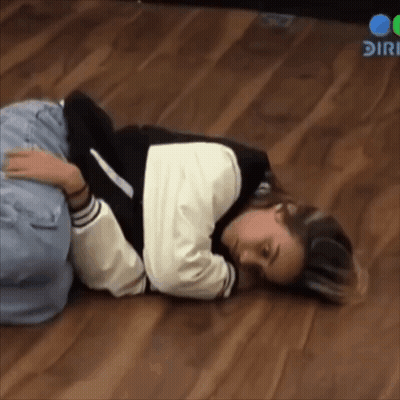 Woman Lying On Floor With Head On Knees GIF