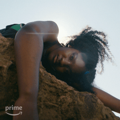 Woman Lying On Rock With Prime Logo GIF