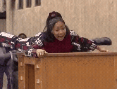 Woman Lying On Wooden Desk With Legs Crossed GIF