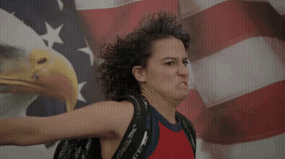 Woman Making Face In Front Of American Flag GIF