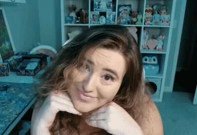 Woman Making Face In Front Of Toy Shelf GIF