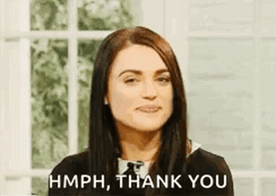 Woman Making Face Saying Hmph Thank You By Window GIF