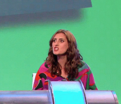 Woman Making Funny Face At Desk Green Background GIF
