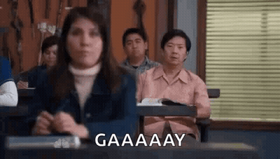 Woman Making Funny Face At Desk In Classroom GIF