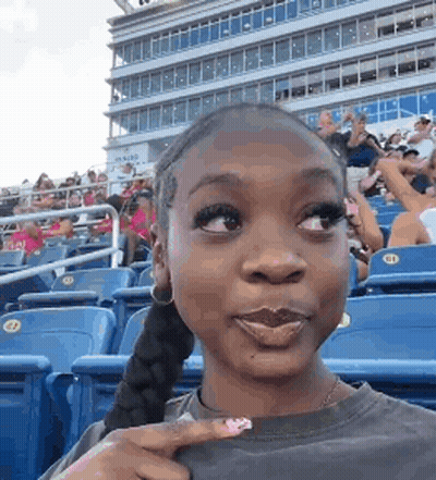 Woman Making Funny Face At Stadium GIF