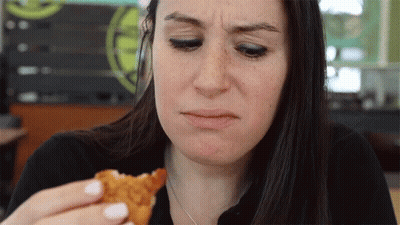 Woman Making Funny Face Eating Chicken GIF