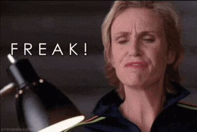 Woman Making Funny Face Holding Lamp With Freak Above GIF