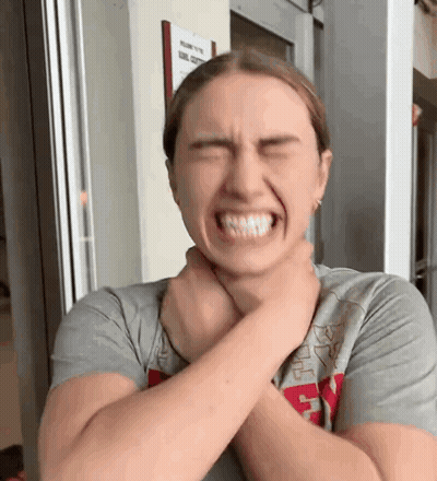 Woman Making Funny Face Holding Neck GIF