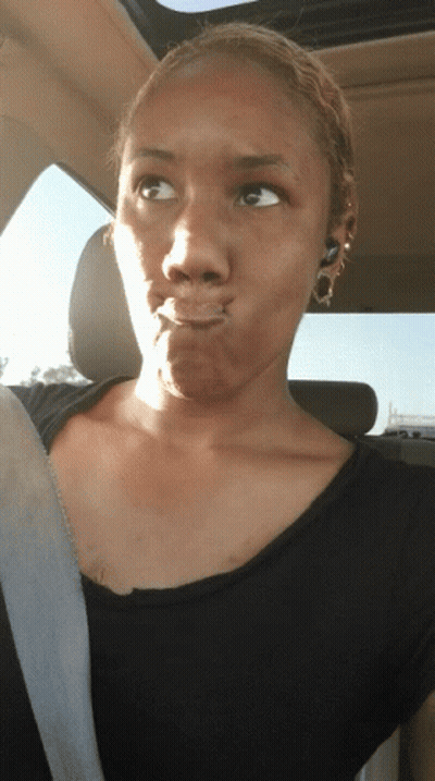 Woman Making Funny Face In Back Seat Of Car GIF